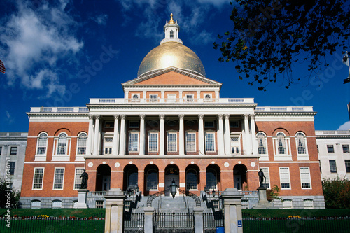 This is the State Capitol building, also known as the State House. It has a gold dome with columns on its facade.