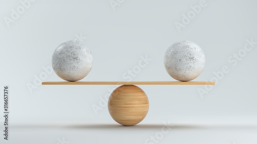 wooden scale balancing two big balls in front white background