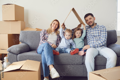 Happy family smiling at a new house moving.