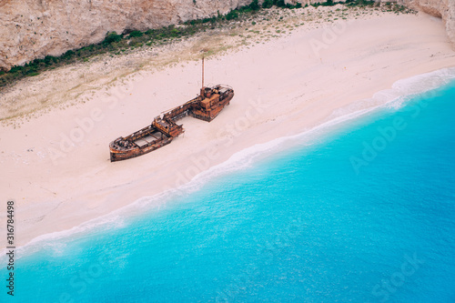 An old rusted ship, wrecked, lies on the seashore. Navagio Bay Shipwreck Beach Greece, Zakynthos