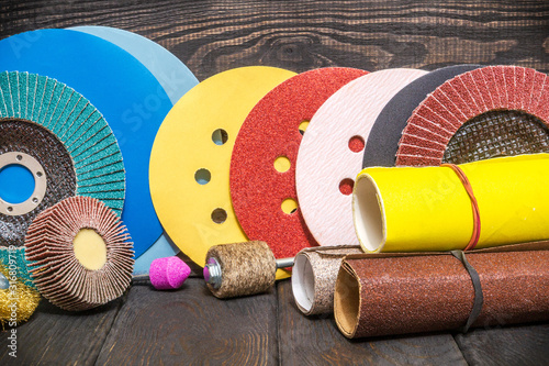 Big set of abrasive tools and multicolored sandpaper on wooden vintage black background