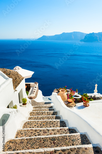White architecture and blue sea on Santorini island, Greece. Stairs to the sea. Summer holidays, travel destinations concept