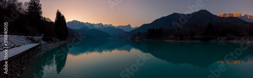 The panorama of the twilight sunset over the lake Barcis, Italy