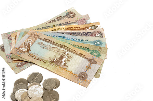United Arab Emirates cash notes and coins isolated on white background. selective focus. high key