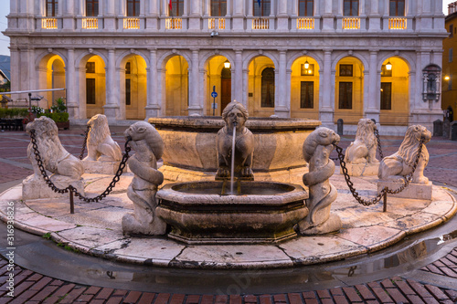 Beautiful fountain of the Piazza Vecchia in Bergamo at dawn, Italy