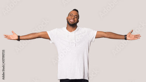 Smiling black man stretch hands show big sales