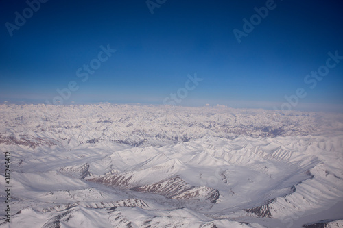 Aerial view landscape with himalaya range mountains from airbus flying from New delhi go to Kushok Bakula Rimpochee Airport at Leh Ladakh village in Jammu and Kashmir, India