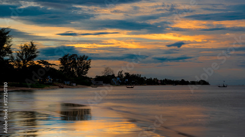 Reflection of coastline of Pak Nam Pran at dusk in Thailand