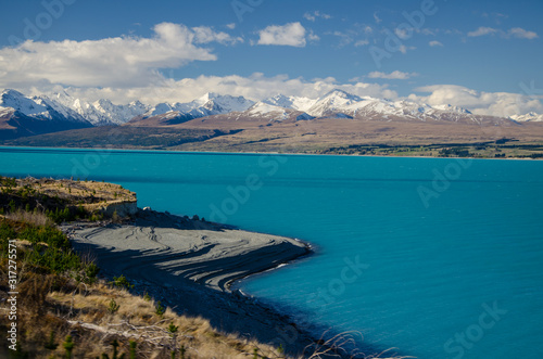 Lake Pukaki with snow covered mountains and blue sky, South Island, New Zealand