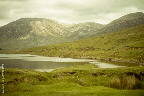 Beautiful lake called Lough Inagh in County Galway, Ireland. Landscape with mountains in the background.