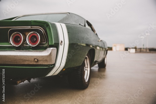 Closeup shot of a green muscle car on a blurred background