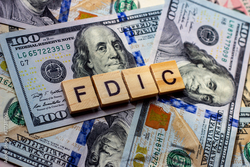 The word fdic on dollar usa background. USA Federal Deposit Insurance Corporation concept.