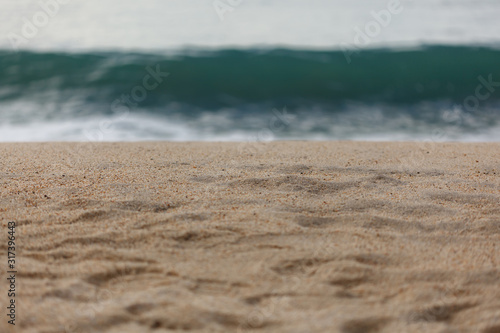 Close up of sand with waves on the background 