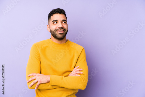 Young mixed race arabic man isolated smiling confident with crossed arms.