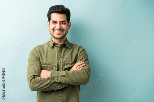 Confident Smiling Man Standing In Studio