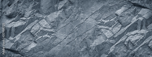 Gray grunge banner. Abstract stone background. The texture of the stone wall. Close-up. Light gray rock backdrop.