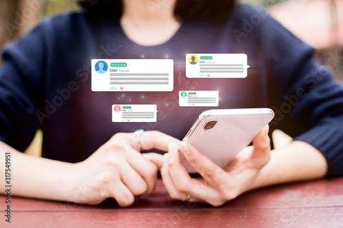 customer experience,review,feedback concept.Hands using mobile phone