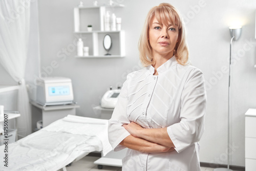 Portrait of successful professional doctor cosmetologist dermatologist woman in her beauty salon smiling in white medical clothes close-up