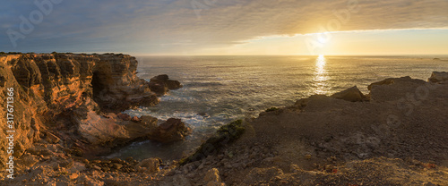 sunset scenery at Costa Vicentina coast, Carrapateira with illuminated cliffs