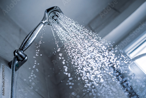 Water running from shower head and faucet in the bathroom,