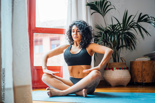 Woman performing abdominal hypopressive exercises