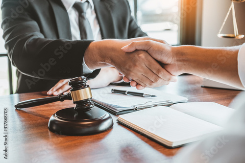 Businessman shaking hands to seal a deal Judges male lawyers Consultation legal services Consulting in regard to the various contracts to plan the case in court.