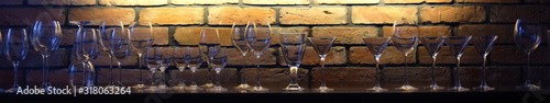 Glasses against the backdrop of an illuminated brick wall