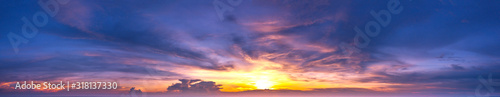 Panorama Sunset with clouds, in orange and colorful shades,World Environment Day concept: Fiery orange sunset sky with dark clouds.