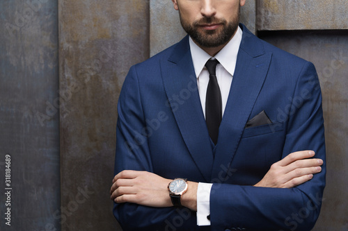 indoor photo of young handsome stylish businessman wearing suit