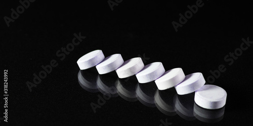 Tablets and pills on dark background