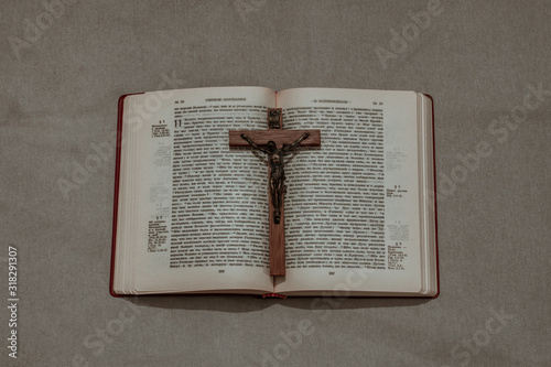 Old wooden Crucifix on the Holy Bible. Concept for exorcism or religious events