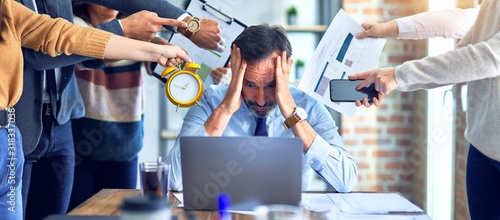 Group of business workers working together. Partners stressing one of them at the office