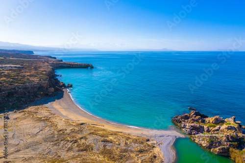 Aerial view of beautiful natural big rock arch Kamara Geropotamou, near sandy beach and river, Rethimno, Crete, Greece.