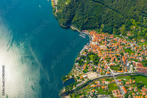 Aerial view of Como lake, Dongo, Italy. Coastline is washed by blue turquoise water