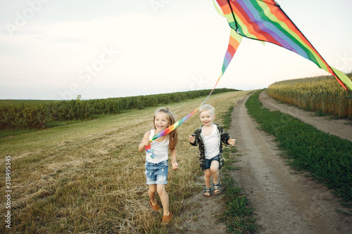 Little child in a summer field. Kids playing with a Kite