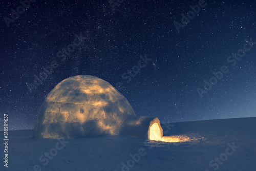 Wintry scene with snowy igloo and milky way in night sky. Fantastic winter landscape glowing by star light. Santa house from snow, ideal New Year and Christmas background