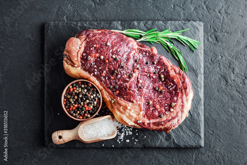 Marbling ribeye steak on slate board. Prime rib beef chop. Food photography