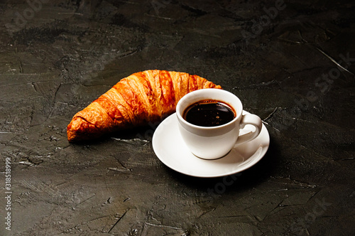 Concept of tasty breakfast, business lunch or coffee break, croissants and espresso on dark gray concrete background