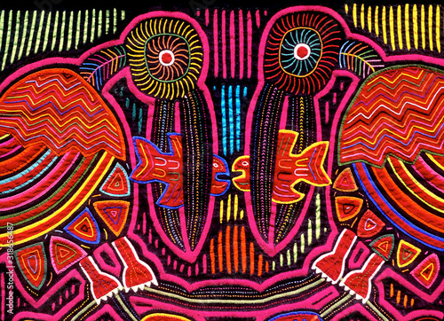 Cuna Mola panel with pelican and fish motif, using the reverse appliqué technique to expose colorful underling layers, San Blas Islands, Panama