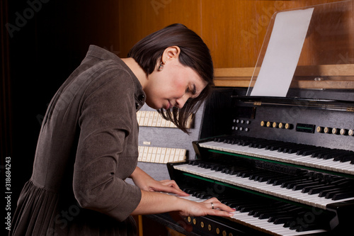 Organist playing a pipe organ, closeup view