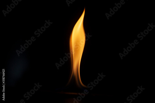 Tongue of fire flame in the dark. Ignition of oxygen in space. Fiery background. Fire of ether in the absence of light. Abstract fire heat background. Single fire. The ignition gel is on.