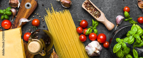 Italian food ingredients of spaghetti: tomatoes, basil, garlic, olive oil and parmesan cheese