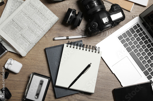 Flat lay composition with equipment for journalist on wooden table