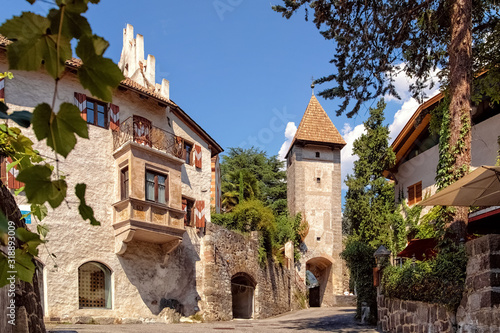 Old town gate Porta Passiria and part of the old town wall in Merano in South Tyrol, Italy