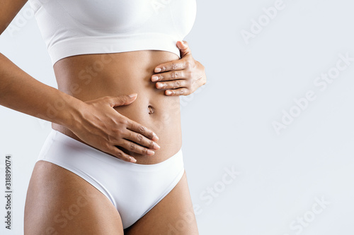 Close up of female beautiful body over grey background