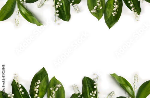 Frame of flower with leaves Lily of the valley ( Convallaria majalis, May bells, may-lily ) on a white background with space for text. Top view, flat lay