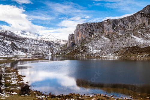 Reflections of snowy mountains over Covadonga Lakes