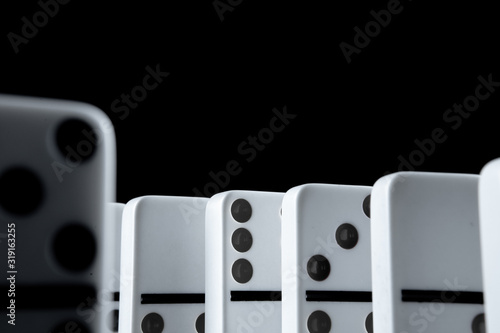 White dominoes in the dark close up