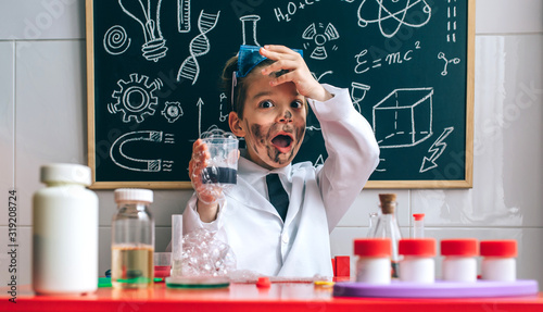 Funny boy dressed as chemist with dirty face after a failed experiment