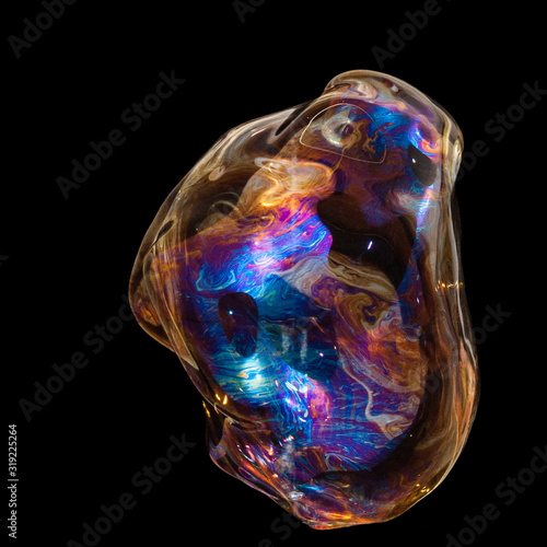 Colorful creative amorphous soap bubble floating with a black background